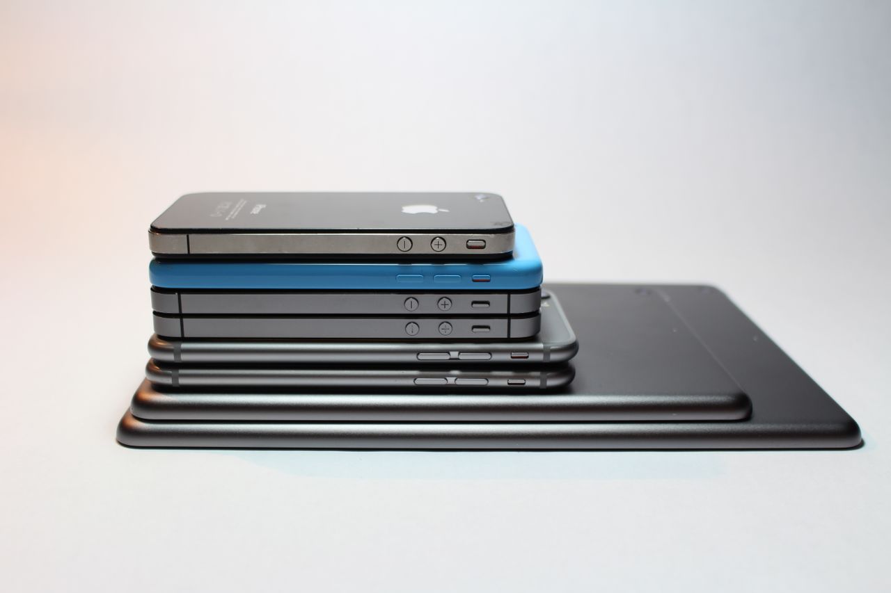 About Stacked modern smartphones and tablets showcasing sleek design. Perfect tech background.